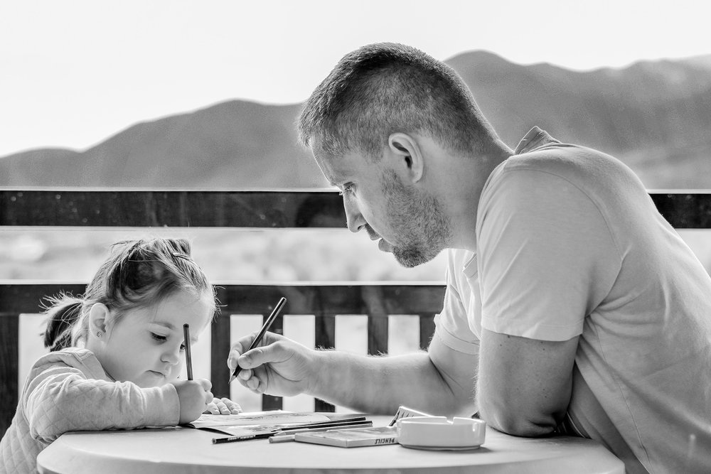 Father and daughter sitting at a table